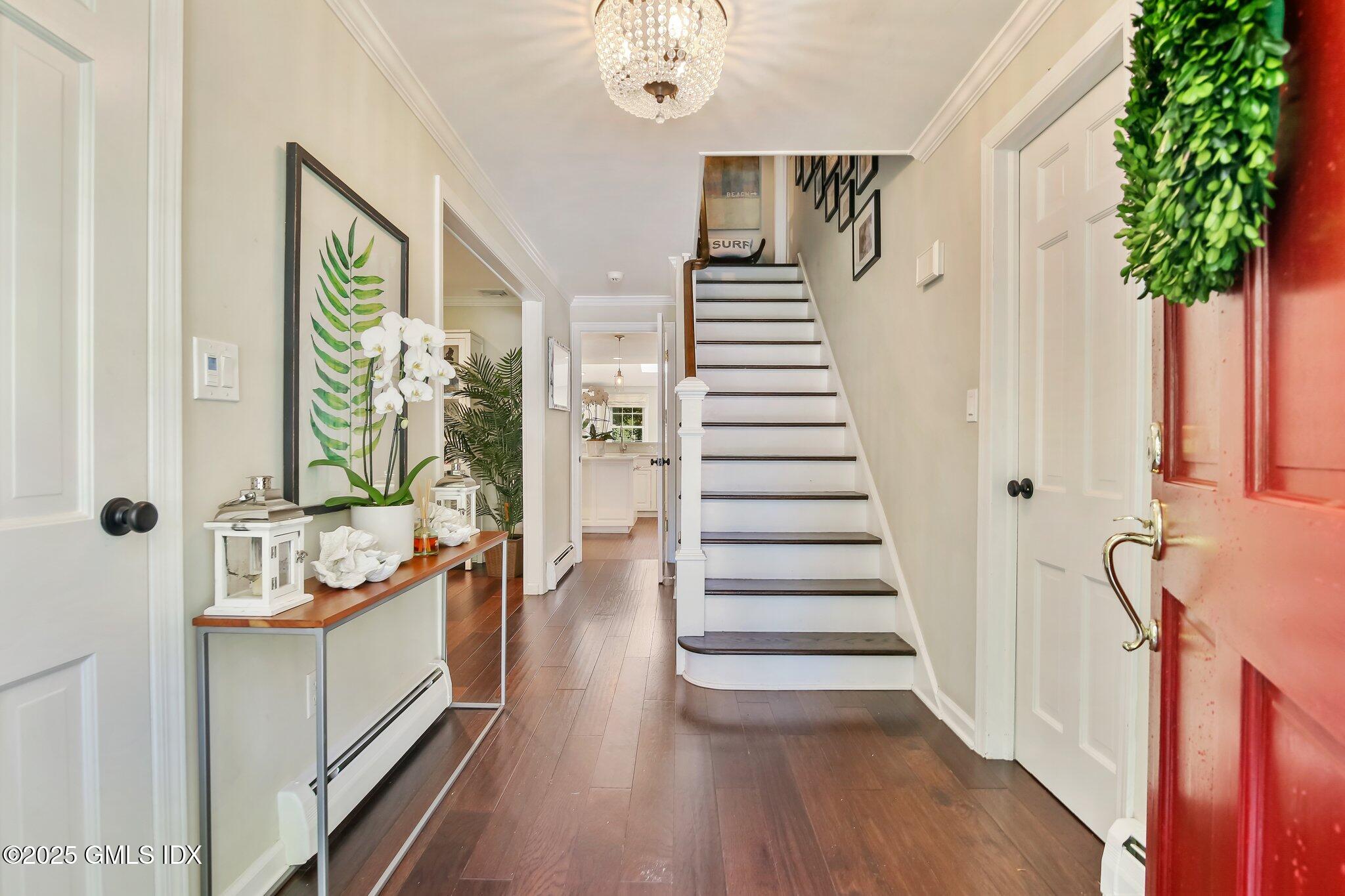 16 Split Timber Place Riverside, CT 06878 - Photo 3 of 34 a view of an entryway with wooden floor and stairs