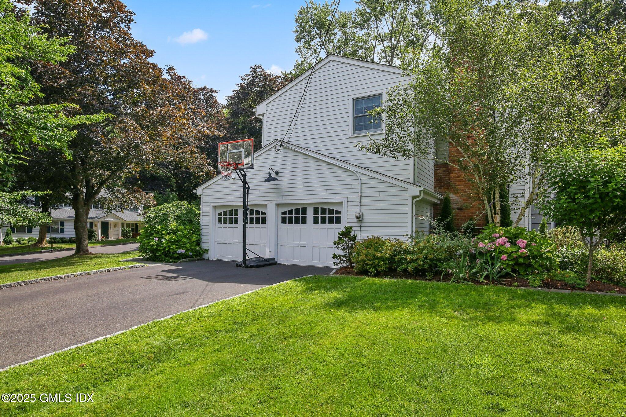 16 Split Timber Place Riverside, CT 06878 - Photo 34 of 34 a view of a house with a big yard and potted plants and large trees
