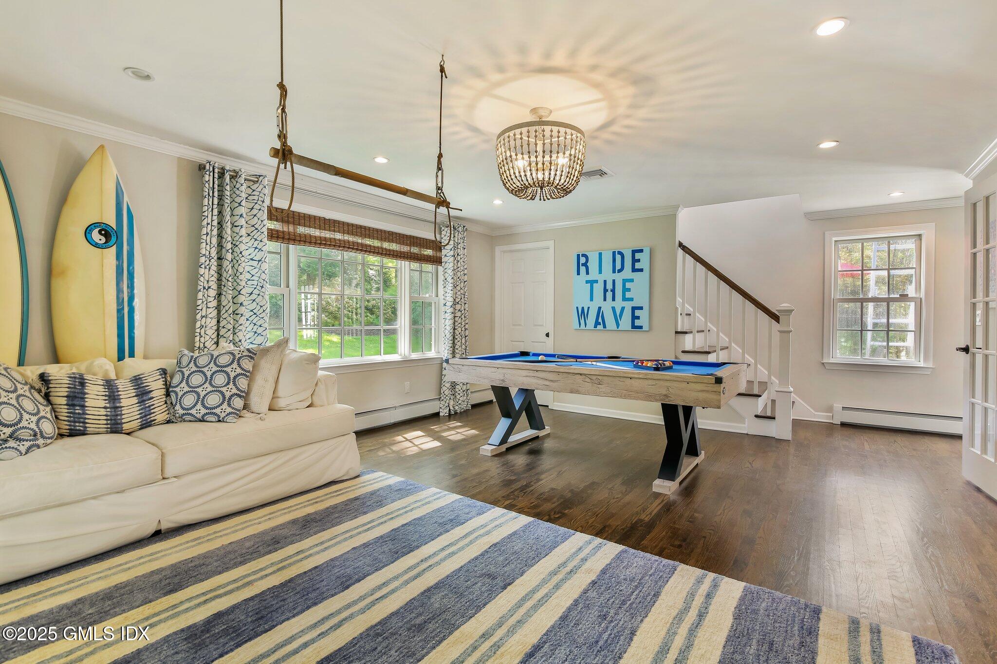 16 Split Timber Place Riverside, CT 06878 - Photo 8 of 34 a living room with furniture a window and a chandelier