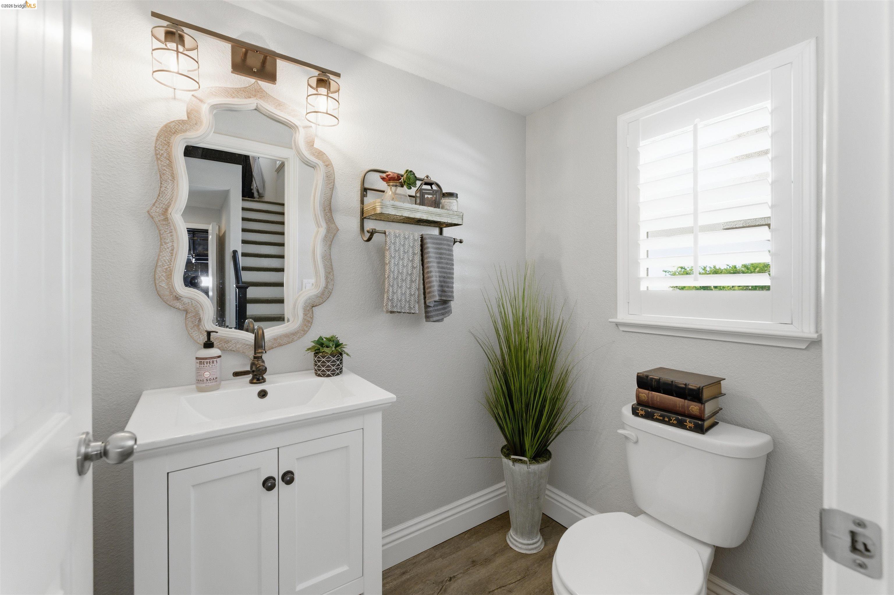 72 Greystone Place Pittsburg, CA 94565 - Photo 18 of 41 a bathroom with a toilet a sink and a mirror