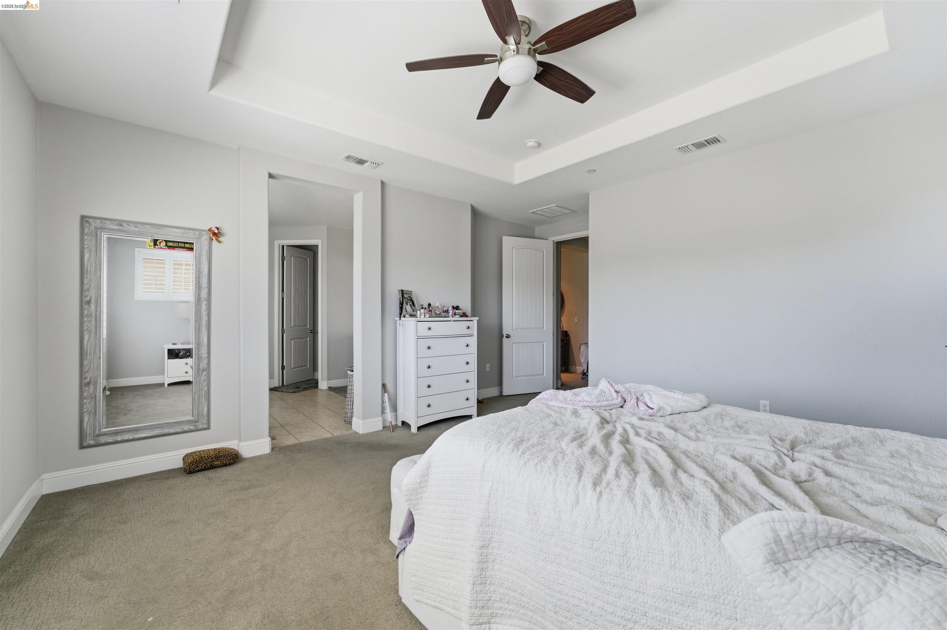 72 Greystone Place Pittsburg, CA 94565 - Photo 25 of 41 a spacious bedroom with a bed and a chandelier