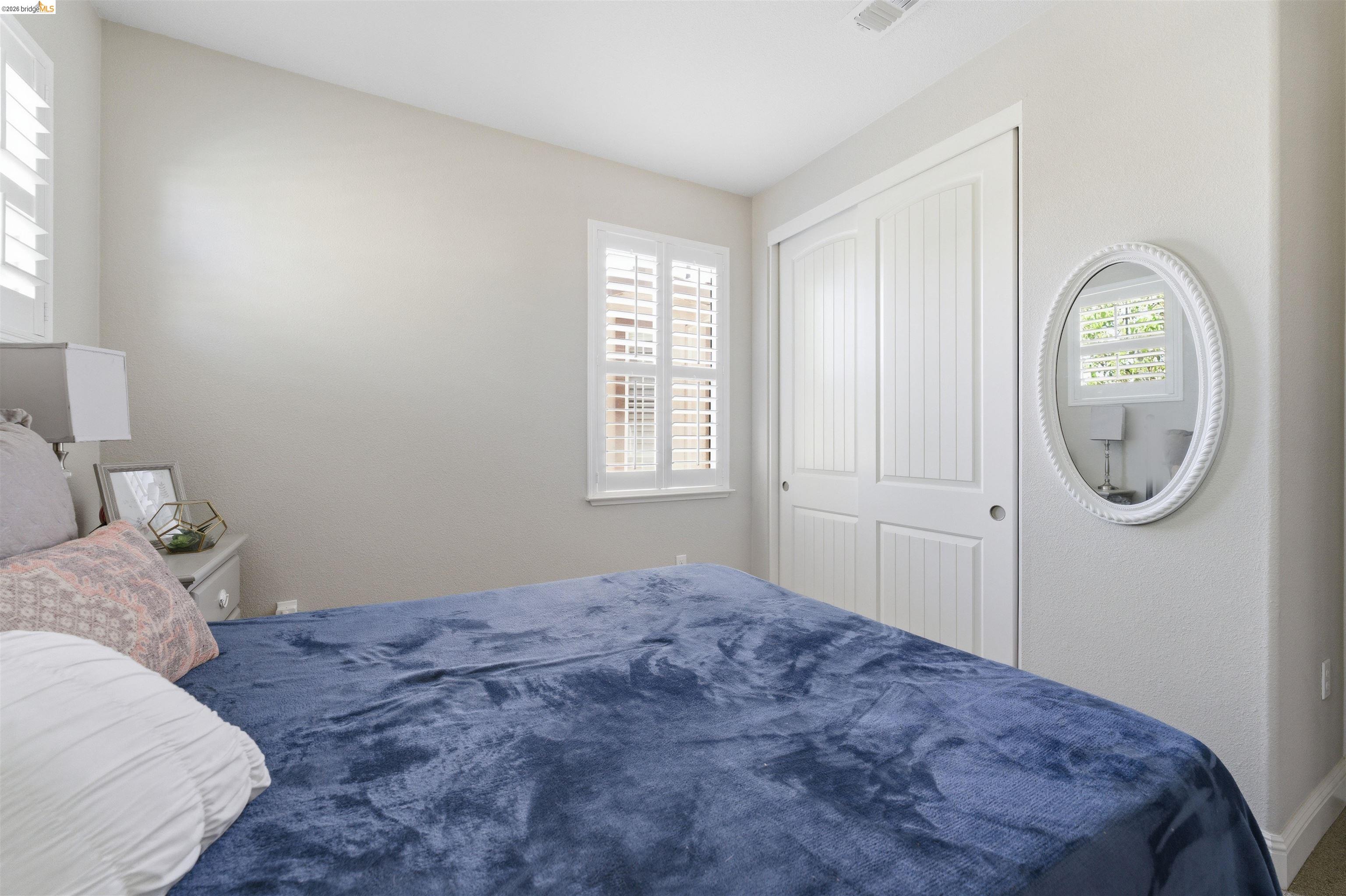 72 Greystone Place Pittsburg, CA 94565 - Photo 34 of 41 a bedroom with a bed and a window