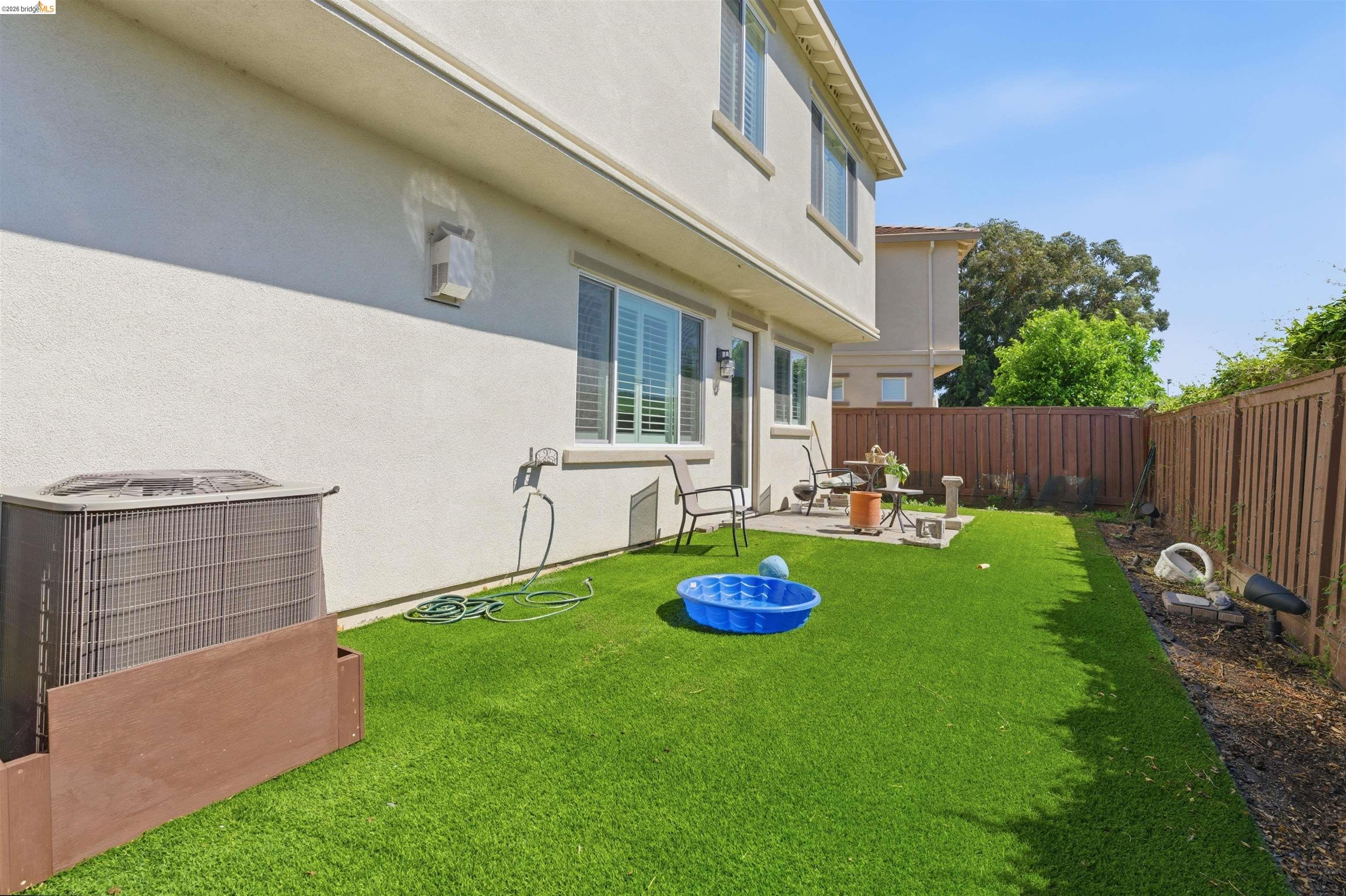 72 Greystone Place Pittsburg, CA 94565 - Photo 35 of 41 a view of backyard with table and chairs and wooden fence