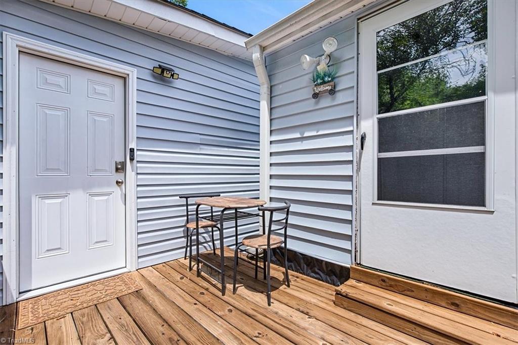 226 Friendly Avenue High Point, NC 27260 - Photo 21 of 38 A private wood deck off the primary suite offers its own outdoor seating area and connects to the suite's separate back entrance, ideal for guests, extended family, or rental flexibility. Please note this suite is unpermitted and full seller disclosures are available.