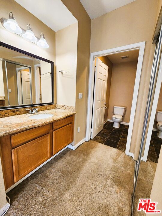 375 Central Avenue, Unit 165 Riverside, CA 92507 - Photo 15 of 24 a spacious bathroom with a granite countertop sink and a mirror