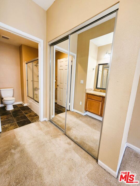 375 Central Avenue, Unit 165 Riverside, CA 92507 - Photo 16 of 24 a bedroom with a bed and a mirror