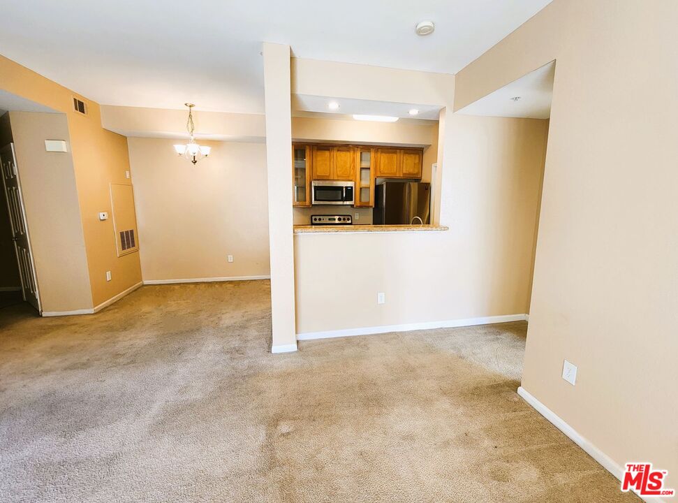 375 Central Avenue, Unit 165 Riverside, CA 92507 - Photo 2 of 24 a view of a big room with closet and wooden floor