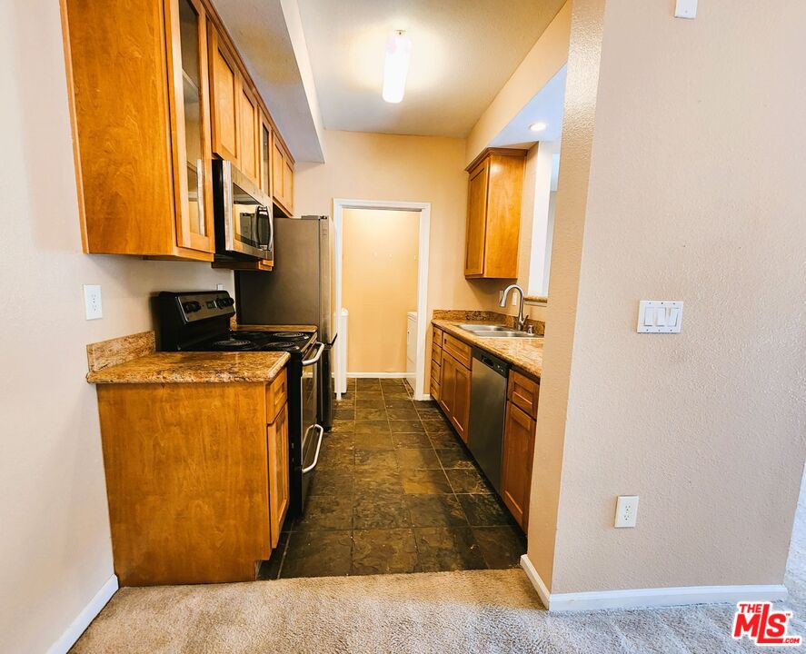 375 Central Avenue, Unit 165 Riverside, CA 92507 - Photo 4 of 24 a kitchen with a sink a counter top space and cabinets
