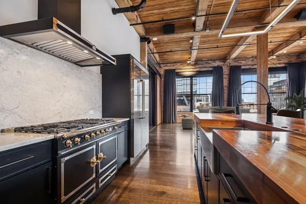 a kitchen with stainless steel appliances granite countertop a stove and a sink
