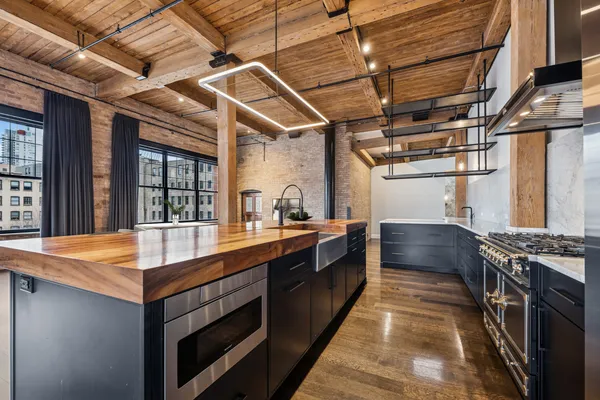 a kitchen with stainless steel appliances granite countertop a stove and a sink