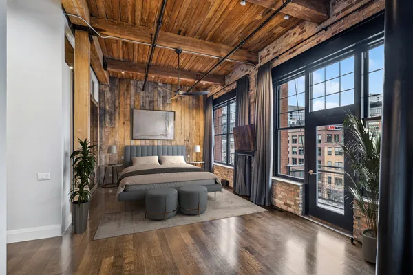 a living room with furniture a flat screen tv and a floor to ceiling window