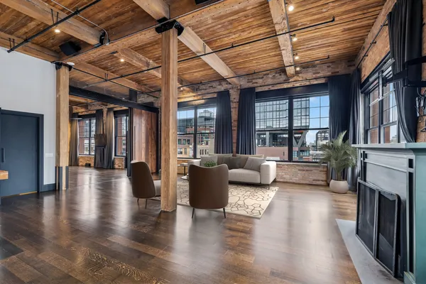 a living room with fireplace furniture and a wooden floor
