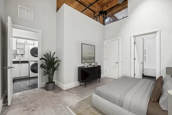 a bed room with a bed and a potted plant