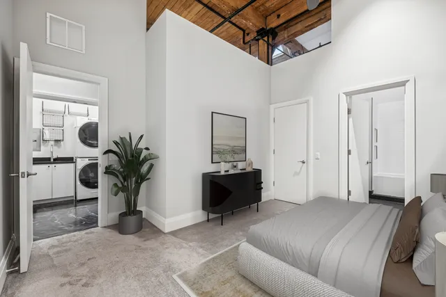 a bed room with a bed and a potted plant