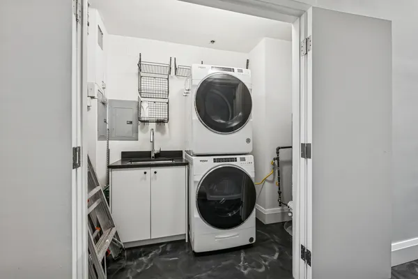 a utility room with sink dryer and washer