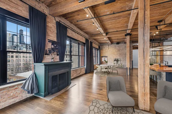 a living room with furniture a fireplace and wooden floor