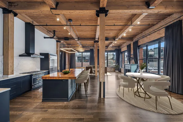 a living room with fireplace furniture and a large window
