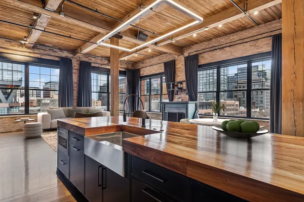 a kitchen with a sink and large windows
