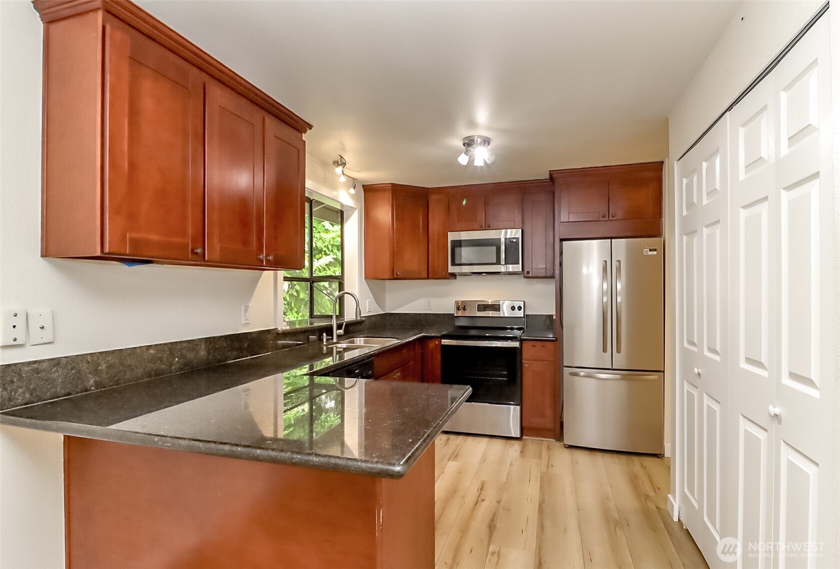 20015 108th Avenue Northeast Bothell, WA 98011 - Photo 13 of 30 a kitchen with granite countertop a refrigerator sink and stove