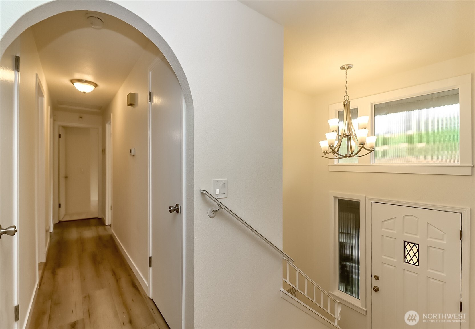20015 108th Avenue Northeast Bothell, WA 98011 - Photo 24 of 30 a view of a hallway with wooden floor and chandelier