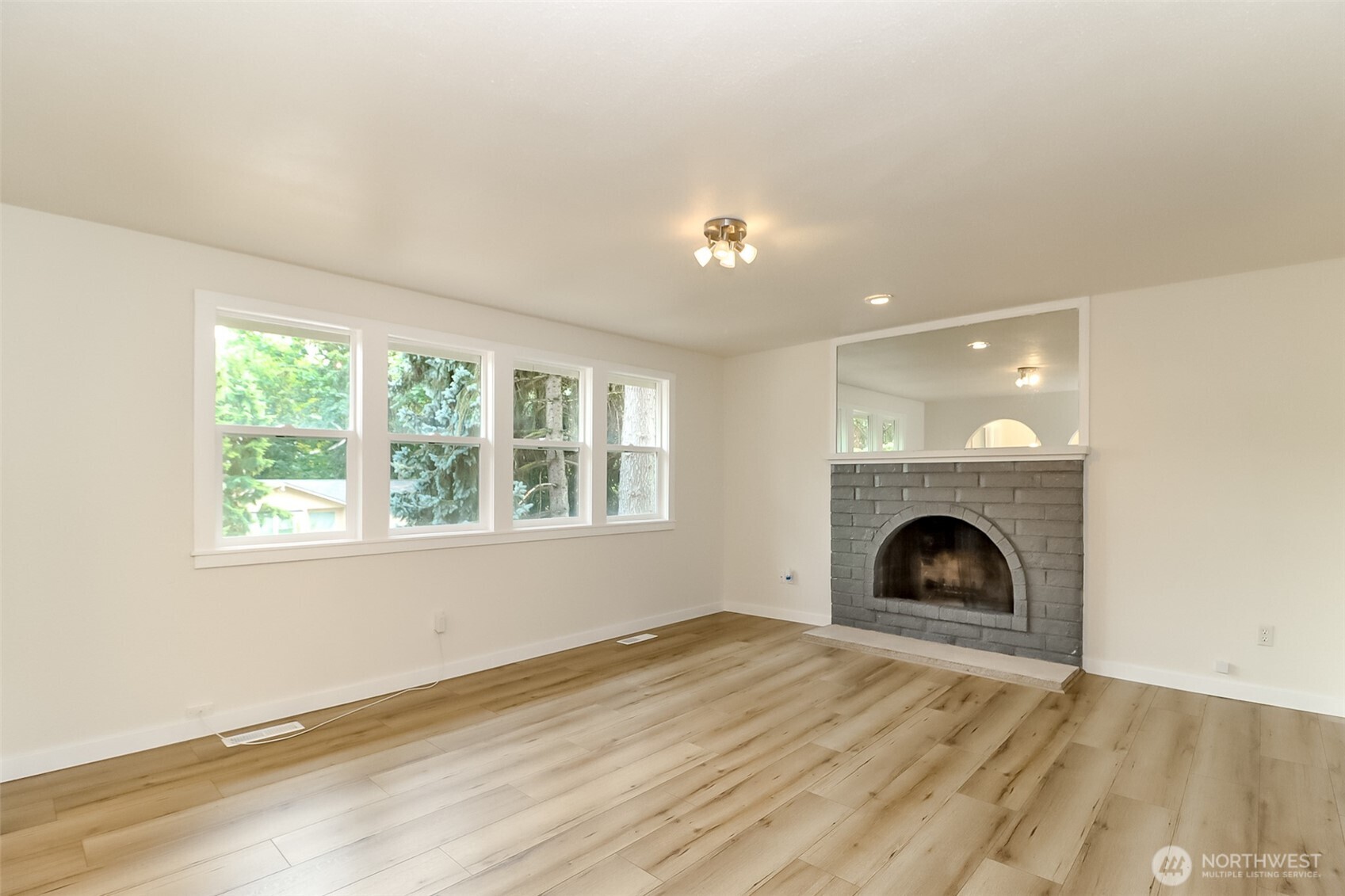 20015 108th Avenue Northeast Bothell, WA 98011 - Photo 27 of 30 a view of an empty room with wooden floor and a window