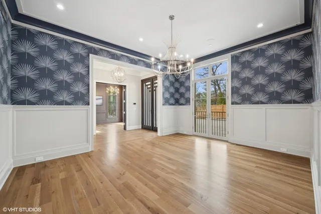 a view of a livingroom with wooden floor and chandelier