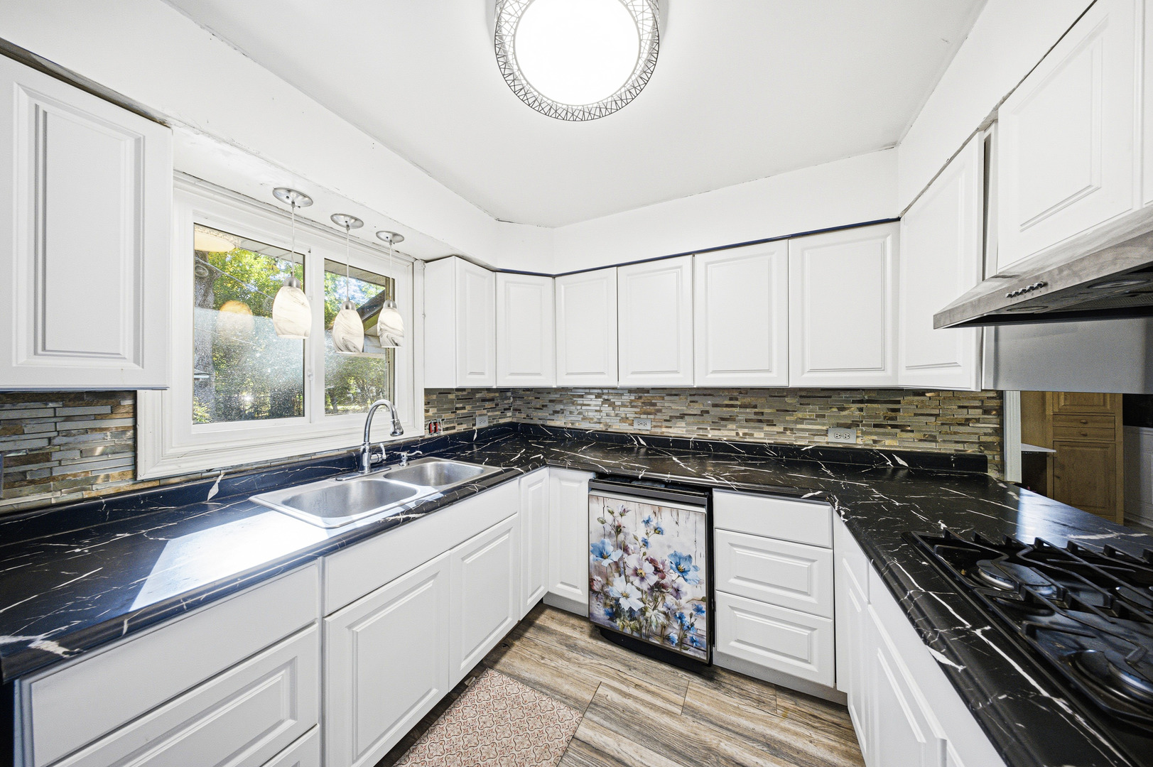 491 Maple Avenue Carpentersville, IL 60110 - Photo 7 of 33 a kitchen with granite countertop a sink a stove and a wooden cabinets