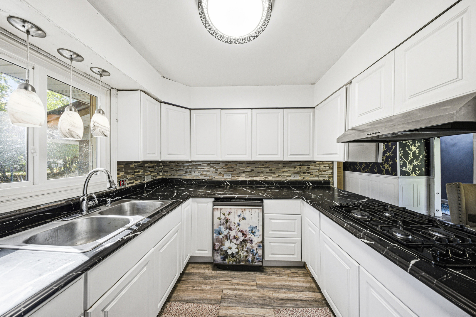 491 Maple Avenue Carpentersville, IL 60110 - Photo 9 of 33 a kitchen with granite countertop a sink a stove and cabinets