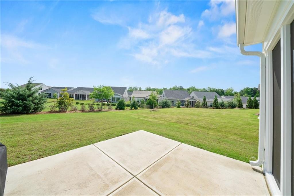2457 Naples Street Hoschton, GA 30548 - Photo 37 of 41 a view of a field of grass and trees