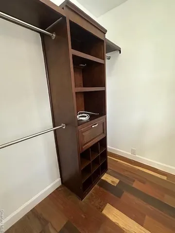a view of walk in closet with empty racks