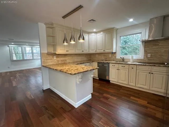 a kitchen with a center island wooden floor and a window