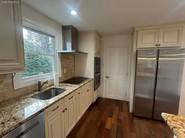 a kitchen with stainless steel appliances granite countertop a sink stove and refrigerator