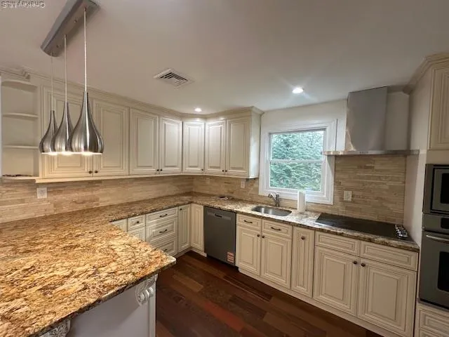 a kitchen with kitchen island granite countertop wooden floors and stainless steel appliances
