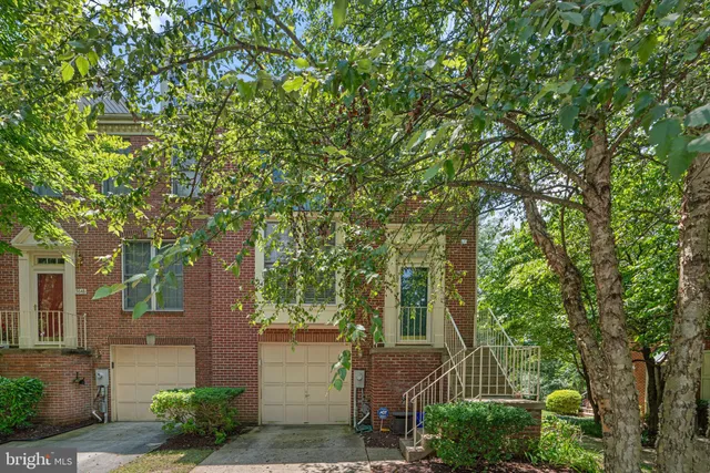 front view of a house with a tree