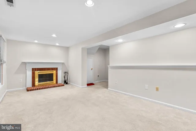 a view of an empty room with a fireplace