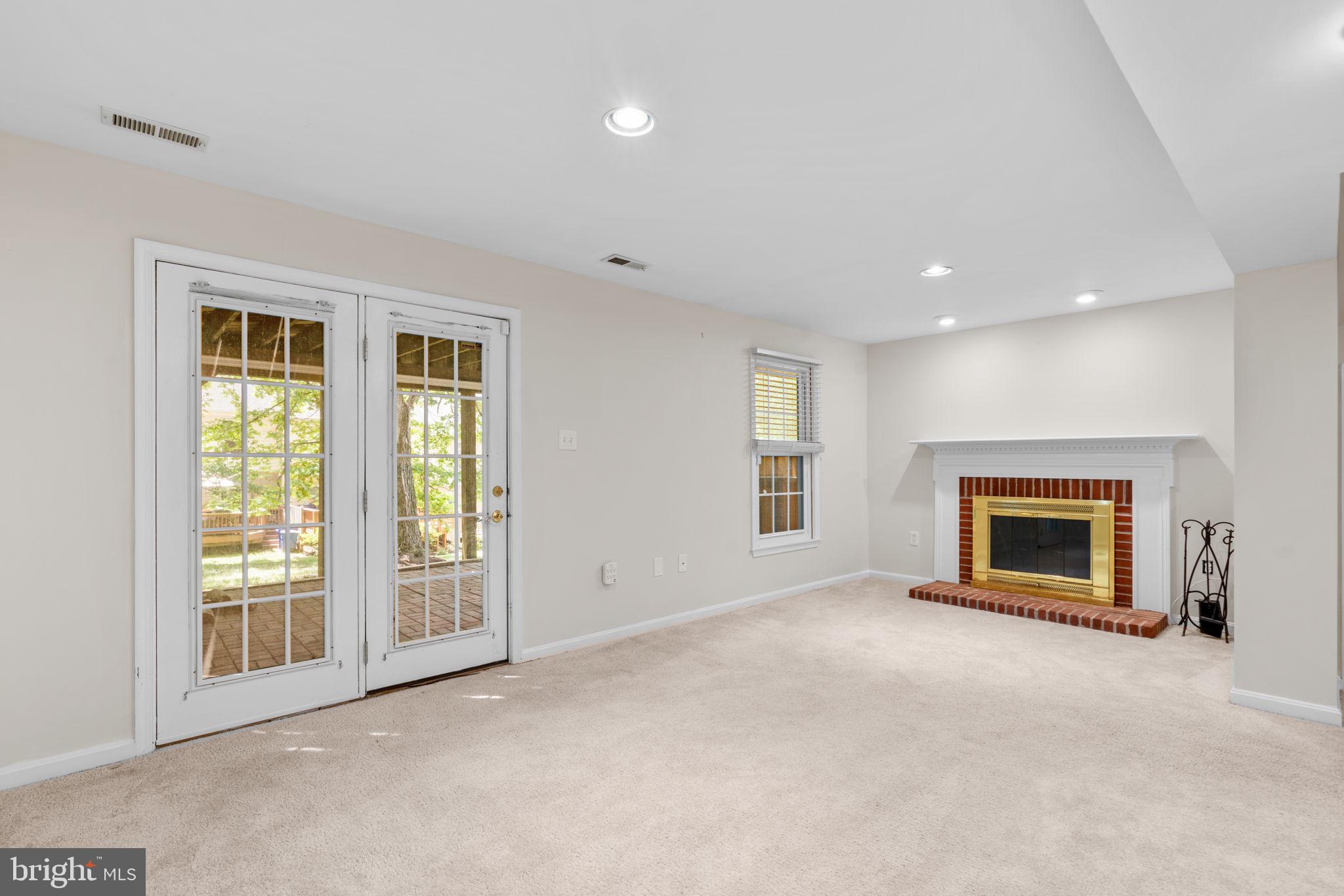 5646 April Journey, Unit 50 Columbia, MD 21044 - Photo 28 of 32 an empty room with windows and fireplace