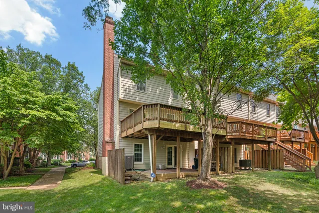 front view of a house with a tree in the yard