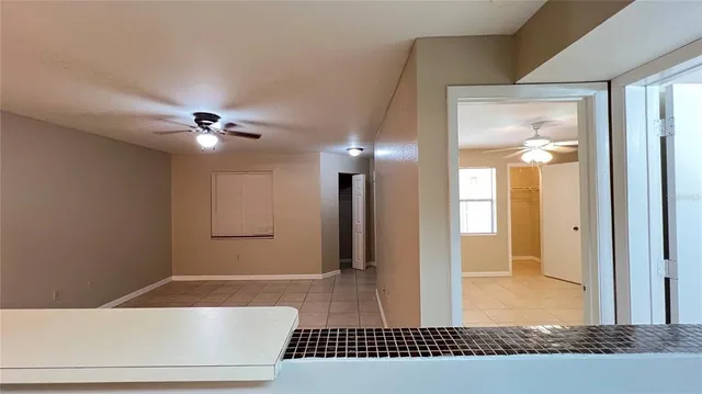 a living room with stainless steel appliances furniture a fireplace and a flat screen tv