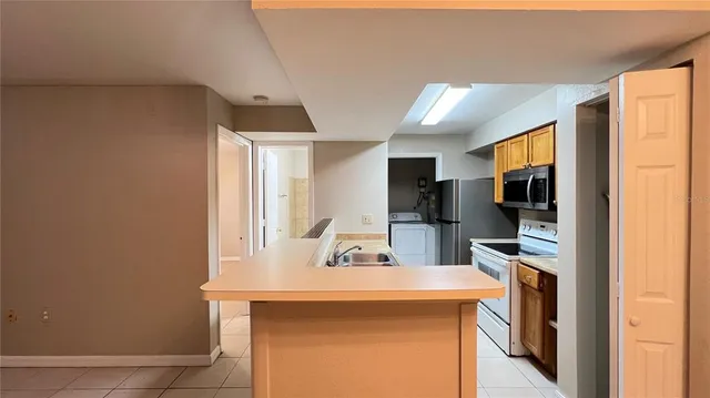 a room with two sink and a refrigerator