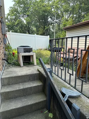a balcony with couple of couches and wooden floor