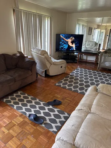 a living room with furniture and a rug