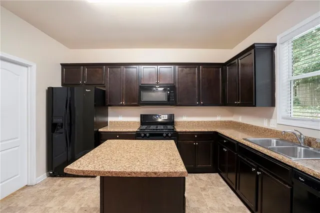 a kitchen with a sink stove and refrigerator