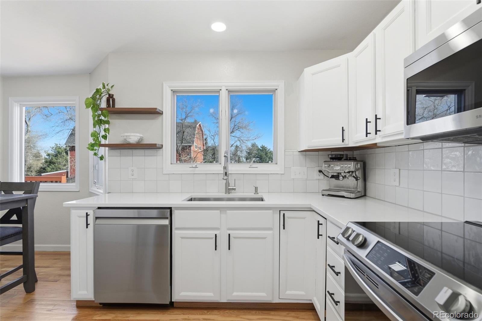 4418 Fig Street Golden, CO 80403 - Photo 11 of 50 a kitchen with a sink cabinets and window