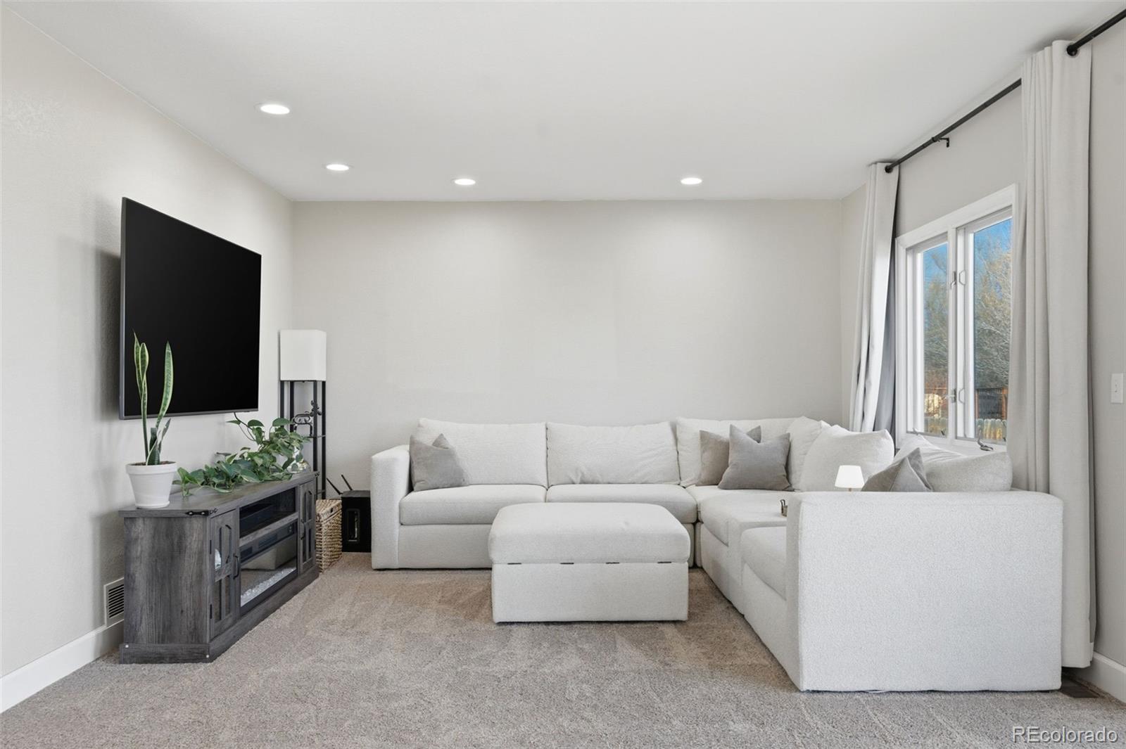 4418 Fig Street Golden, CO 80403 - Photo 13 of 50 a living room with furniture and a flat screen tv