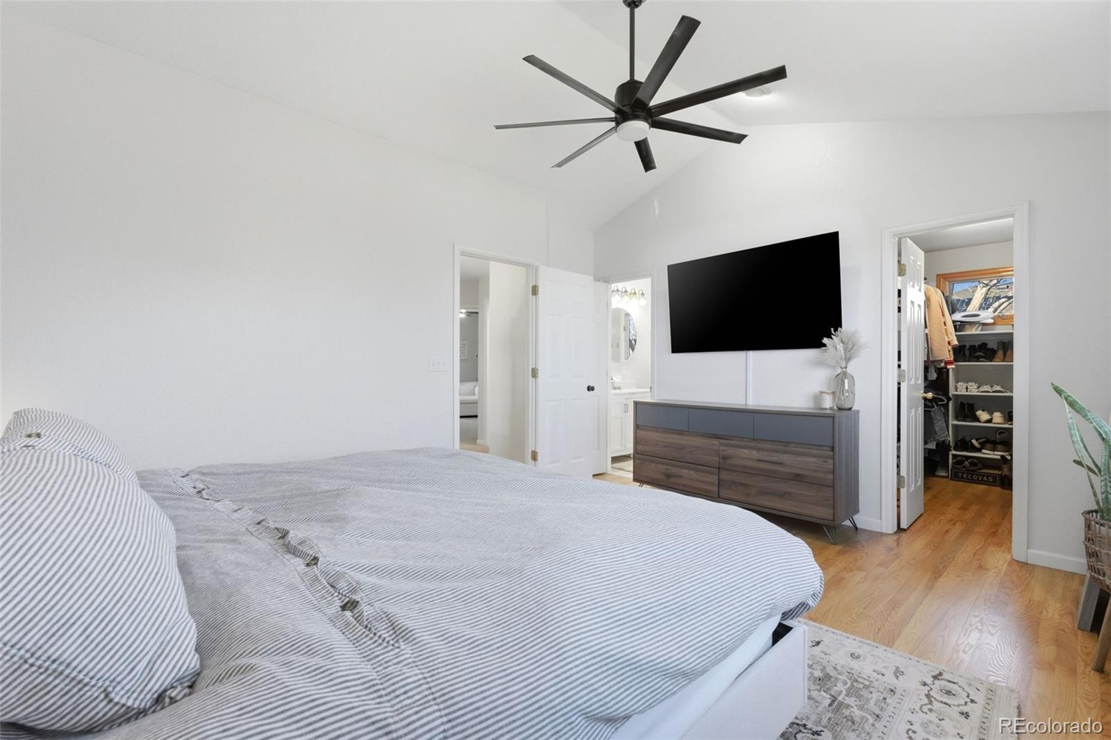 4418 Fig Street Golden, CO 80403 - Photo 20 of 50 a bedroom with a bed and a flat screen tv