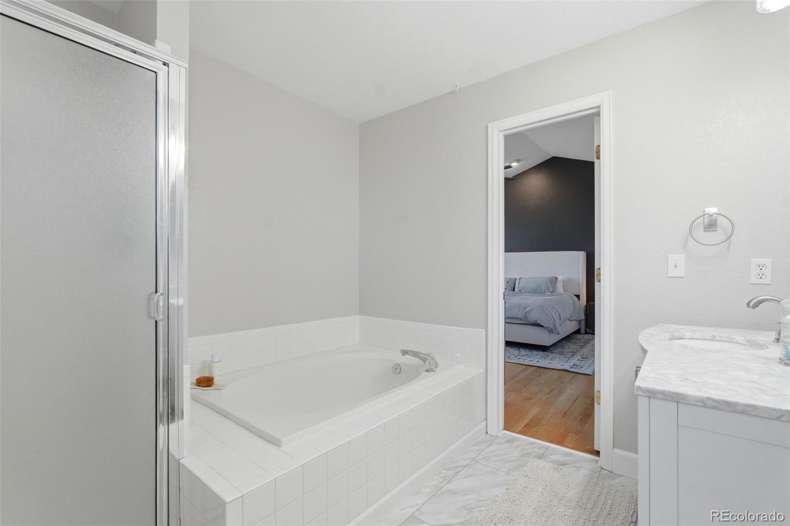4418 Fig Street Golden, CO 80403 - Photo 23 of 50 a en suite bathroom with a tub and shower