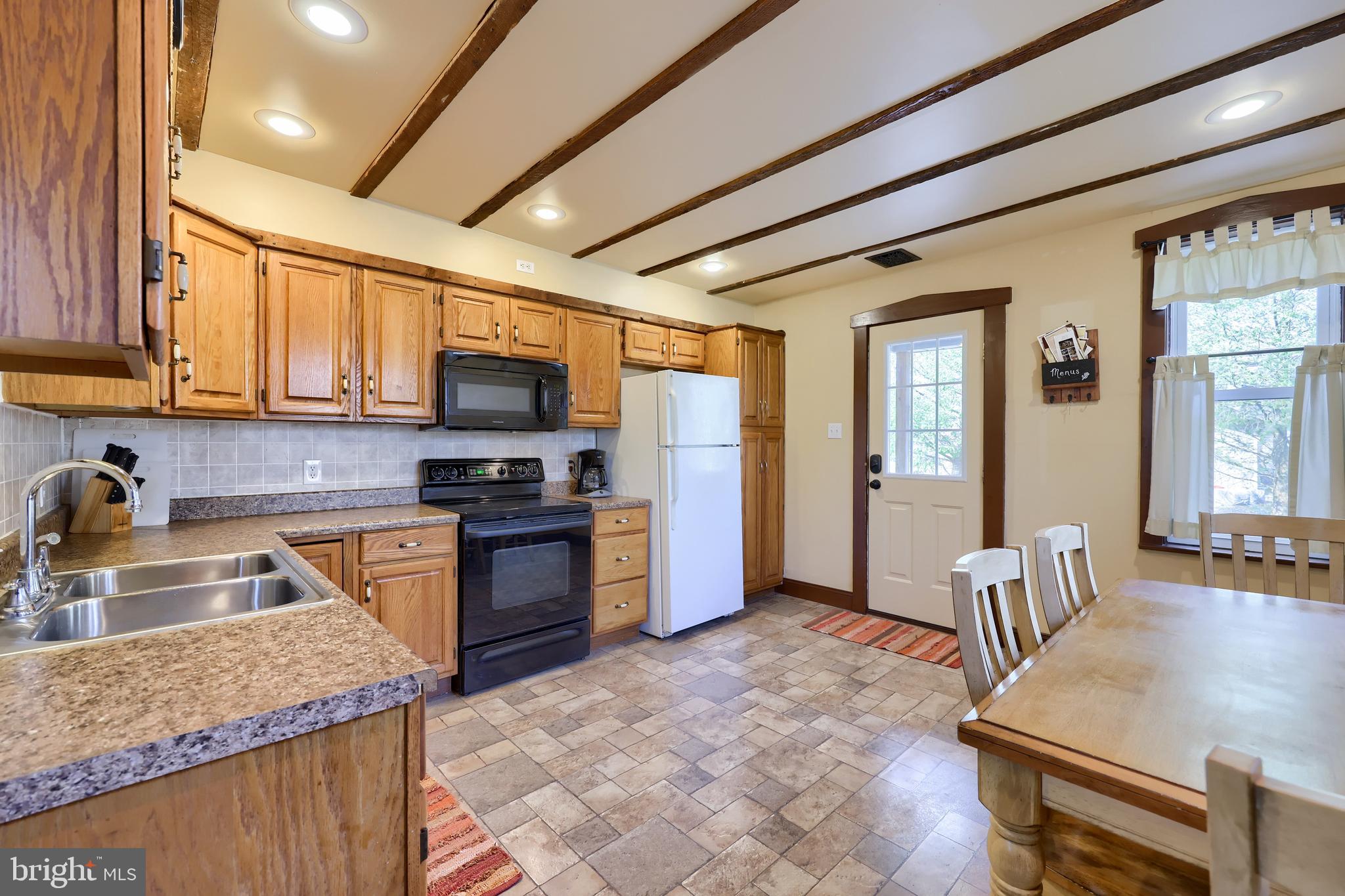 420 North Water Street Lititz, PA 17543 - Photo 31 of 43 a kitchen with granite countertop wooden cabinets a sink stove and refrigerator