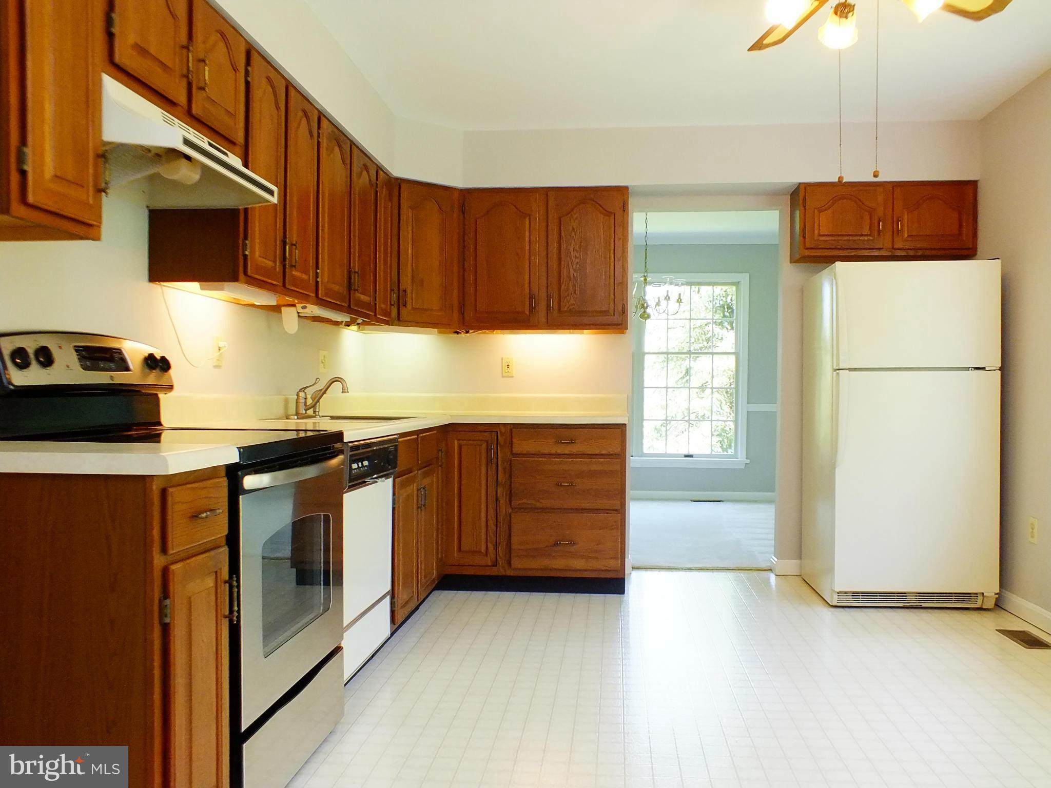 18249 Falls Road Hampstead, MD 21074 - Photo 7 of 30 a kitchen with stainless steel appliances granite countertop a refrigerator a stove and a sink