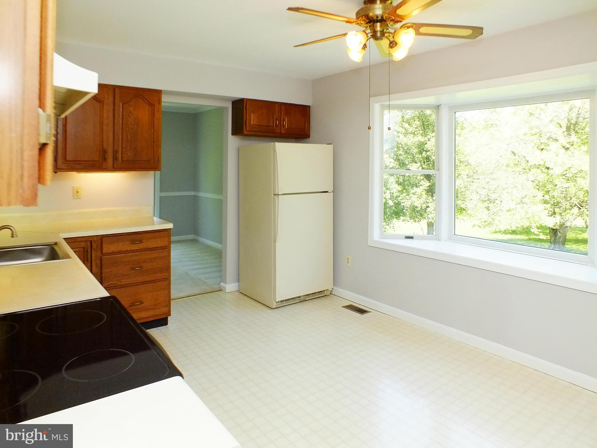 18249 Falls Road Hampstead, MD 21074 - Photo 8 of 30 a view of a kitchen with a sink cabinet and a window