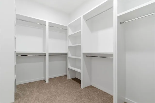 an empty room with a ceiling fan and shower